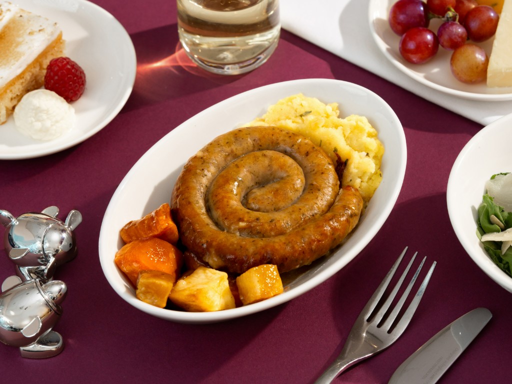 Cumberland sausage with parsley mashed potatoes, root vegetables and madeira sauce