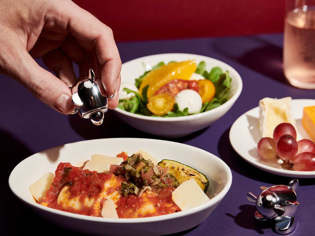 Basil and ricotta ravioli with tomato sauce, roasted baby courgette shaved hard italian cheese and salsa verde 