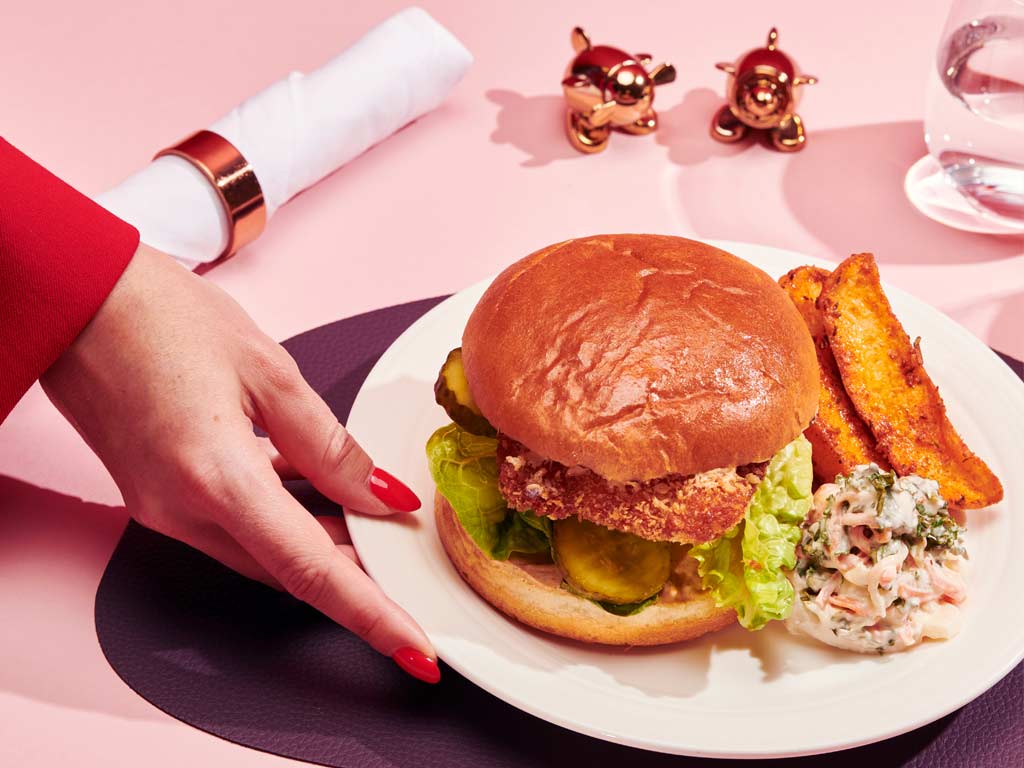   Buttermilk chicken burger in a brioche bun with baby gem, dill pickle and chipotle mayonnaise served with spiced potato wedges and coleslaw (Pre-order exclusive)